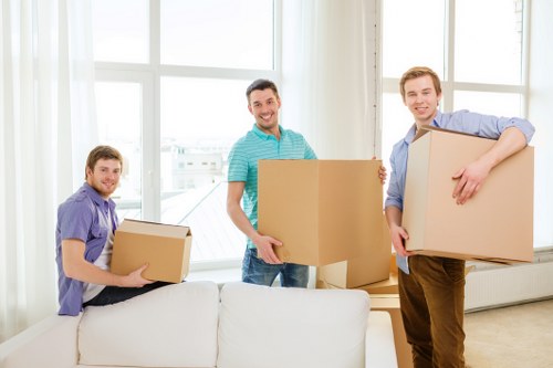 Packed moving boxes and household items ready for collection in Woolwich