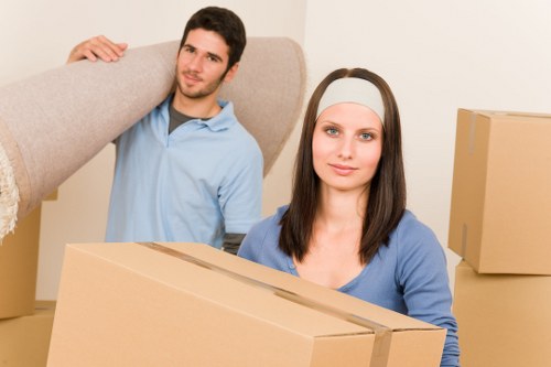 Professional movers handling packed boxes for a Woolwich relocation